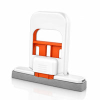 Foldable mini mop cleaner with white and orange handle standing on a white surface