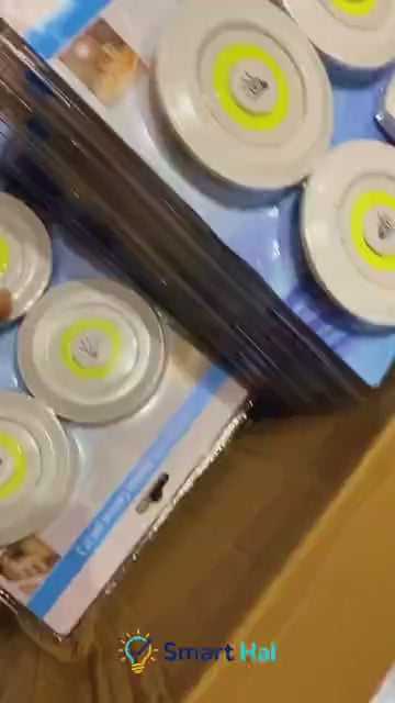 LED tap lights illuminating a home shelf